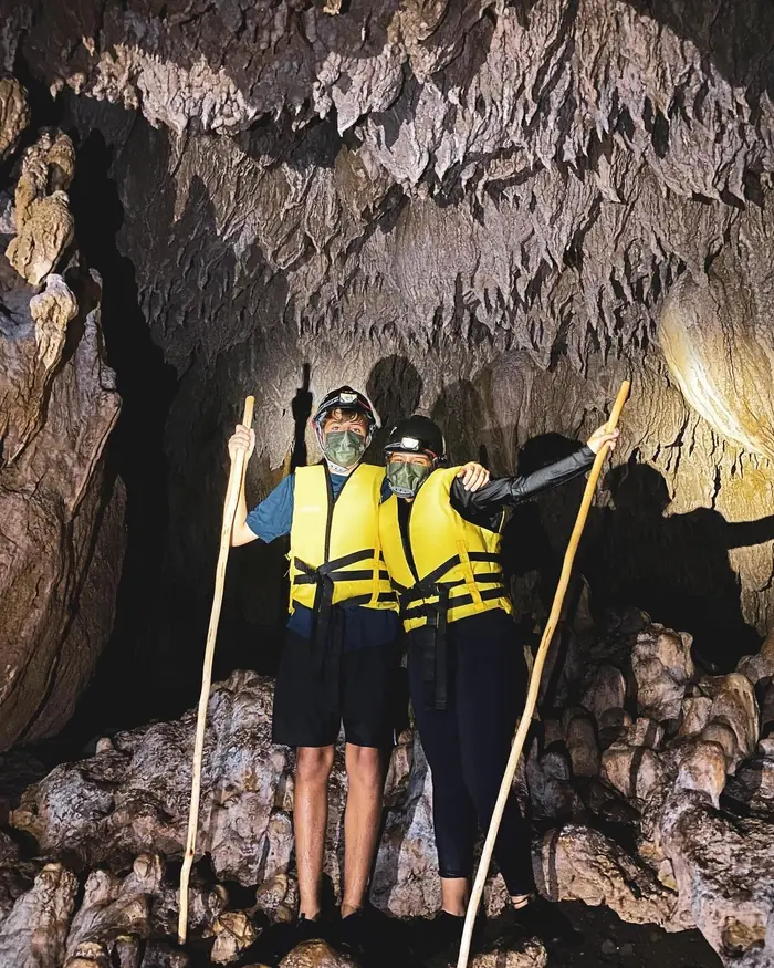 Visitantes con casco y salvavidas dentro de la cueva